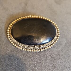 Elegant Black and Gold Brooch